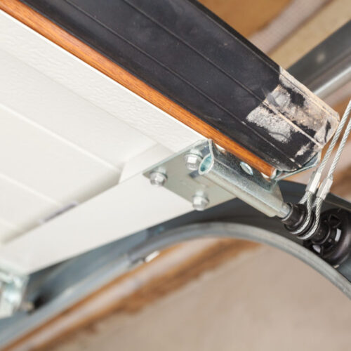 Garage doors installation. Close up of lifting system in metal profil